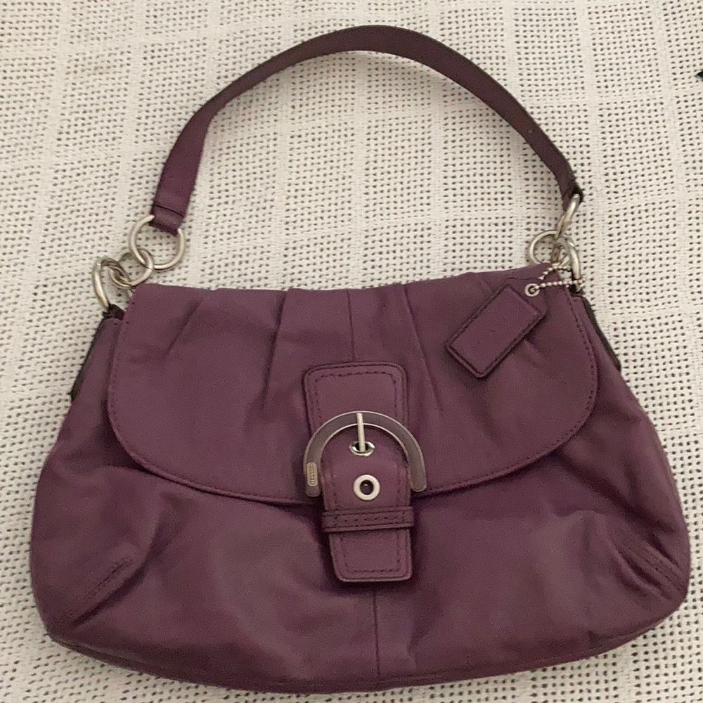 Gently used purple coach bag 14” shoulder strap with button closure